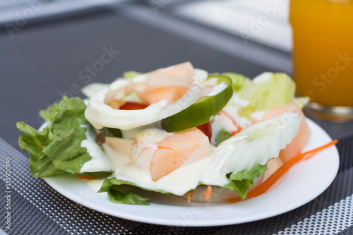 Salad and orange juice, breakfast in the hotel.