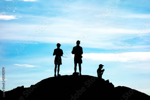 Three Guys taking a Break on Top of a Mountain