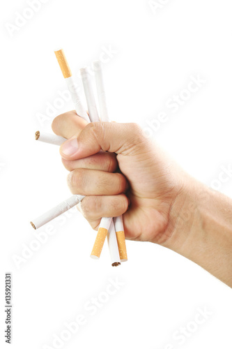 Male hand crushing cigarettes on white background