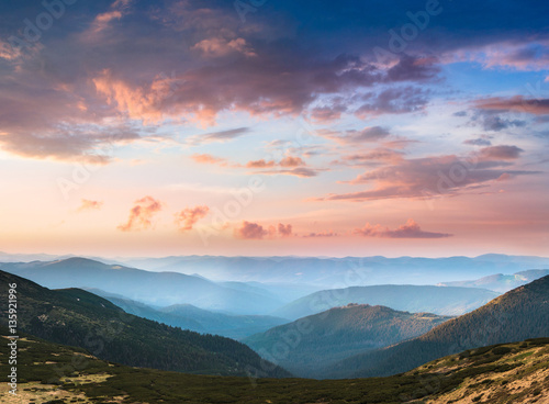 Beautiful landscape in the mountains at sunset. View of colorful sky with clouds.
