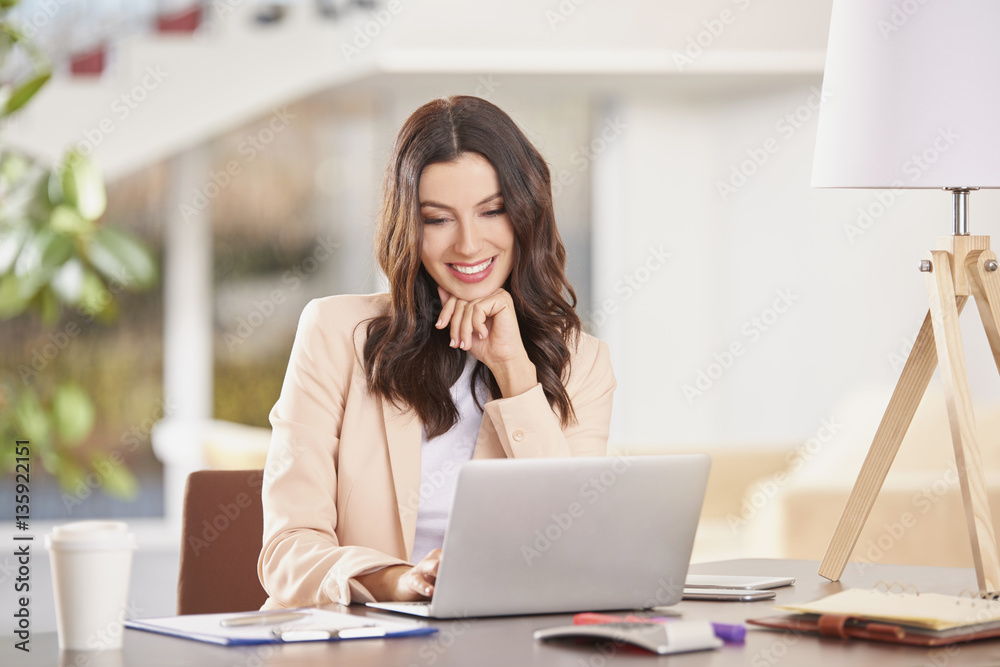 Professional advisor businesswoman. Shot of a young thoughtful woman sitting in front of laptop and working online in the office. Professional advisor businesswoman. Shot of a young thoughtful woman sitting in front of laptop and working online in the office.