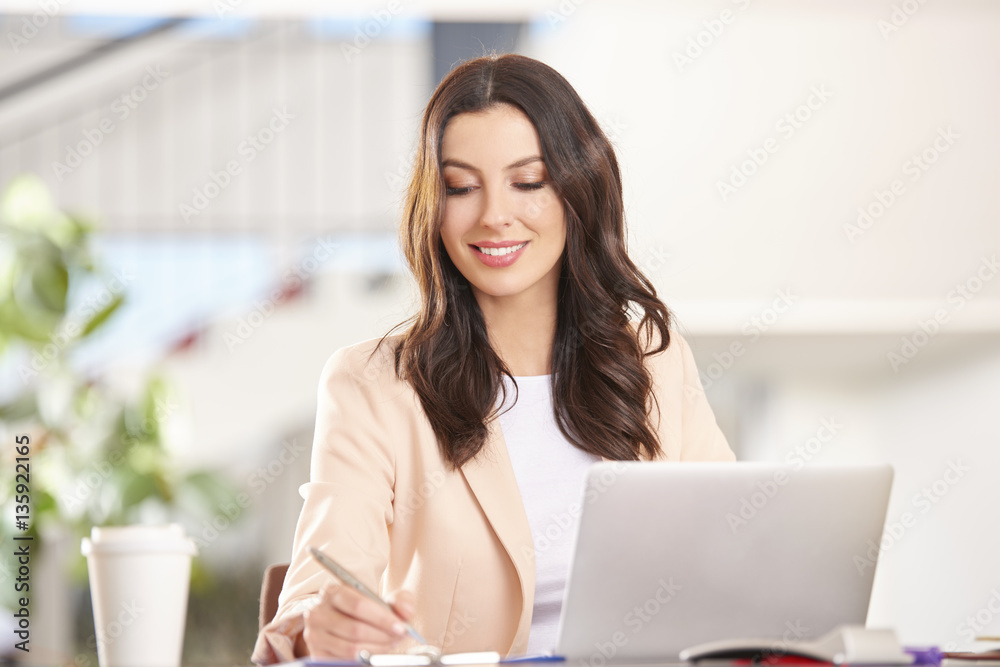 Professional advisor businesswoman. Shot of a young thoughtful woman sitting in front of laptop and working online in the office. Professional advisor businesswoman. Shot of a young thoughtful woman sitting in front of laptop and working online in the office.