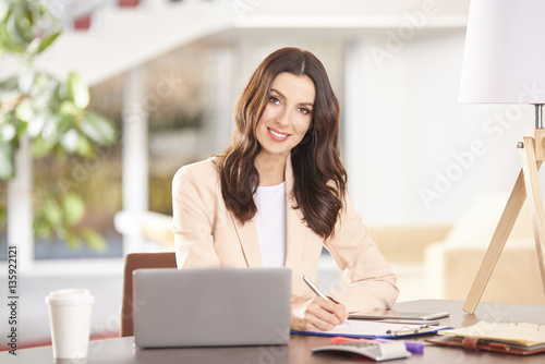 Professional advisor businesswoman. Shot of a young thoughtful woman sitting in front of laptop and working online in the office.