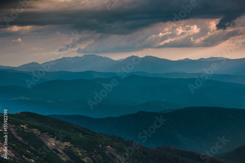 Sunset over layers of mountains. © vovik_mar