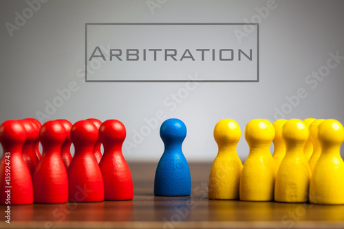 Arbitration concept with pawn figurines on table, grey backgroun photo