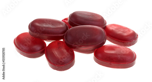 Group of menthol cherry flavored cough drops isolated on a white background.