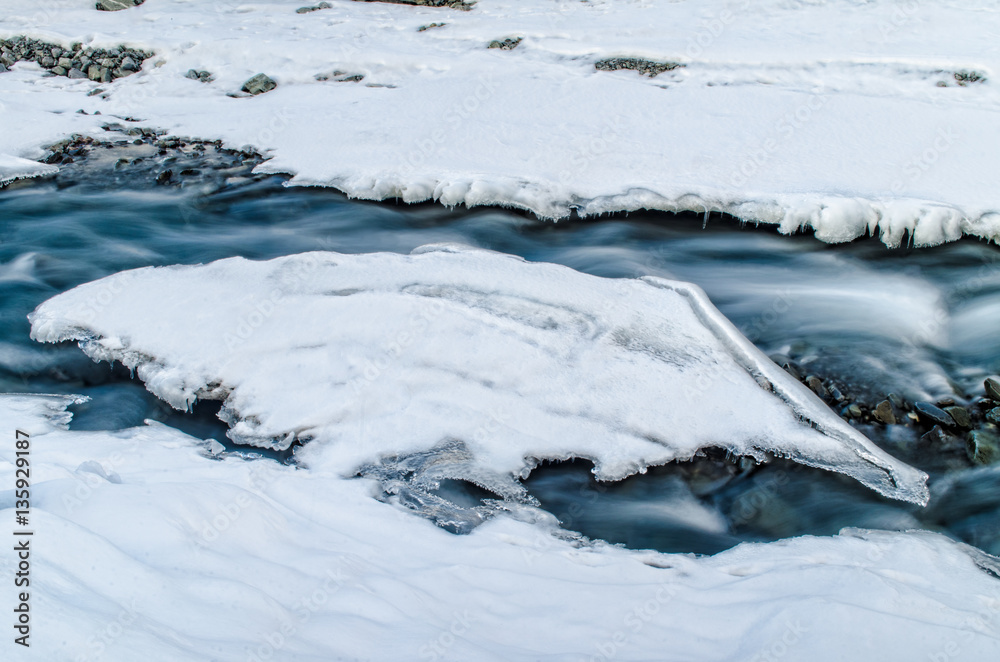 Winter river landscape. Snow covered stream at the mountains of Azerbaijan. Caucasus