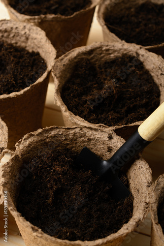 Peat pots with soil and shovel