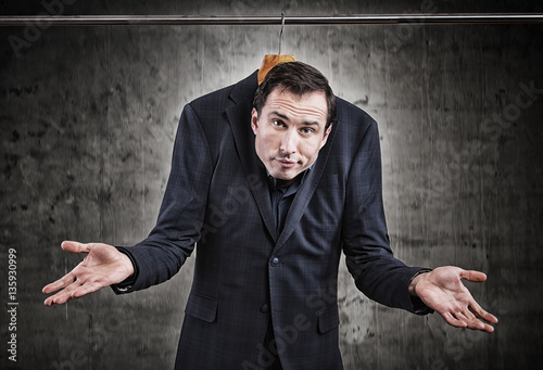 Man in suit hanging in the wardrobe. Embarrassing situation concept

