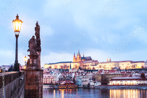 Scenic view to Lesser Town (Mala Strana), Prague Castle and Charles Bridge from the other side Vltava river, illuminated by the city lights. 