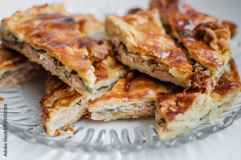 Chunks of fish cake lie on a glass plate. Close-up. Chunks of fish cake lie on a glass plate. Close-up.