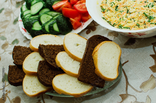 slices of white and black bread lie on a plate photo