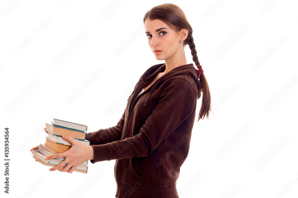 young beautiful student girl with books in her hands posing isolated on white background in studio young beautiful student girl with books in her hands posing isolated on white background in studio