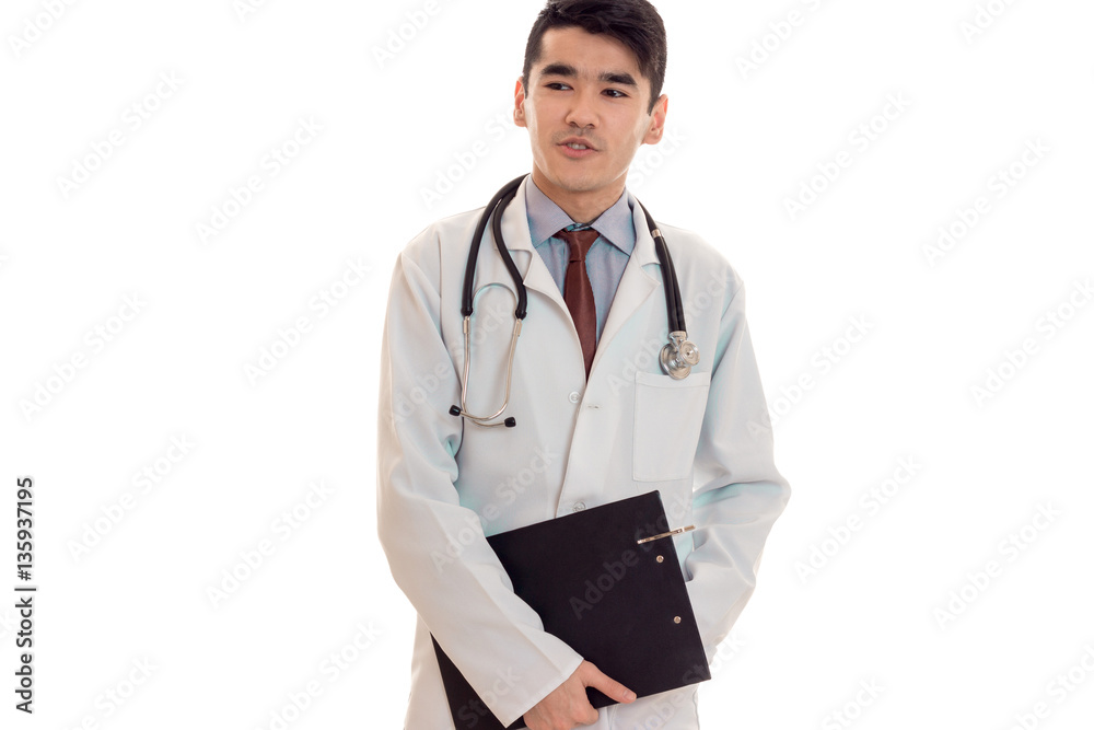 studio portrait of young male doctor in uniform posing isolated on white background studio portrait of young male doctor in uniform posing isolated on white background