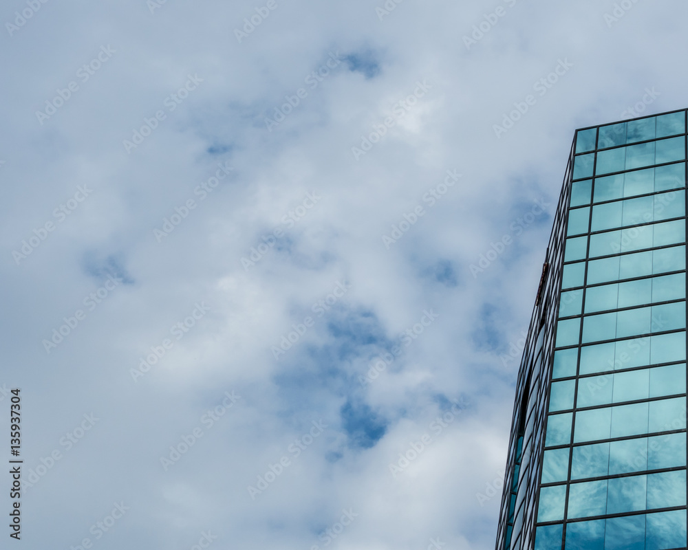 Modern glass building reflecting sky Modern glass building reflecting sky