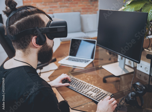 The young man wearing virtual reality goggles