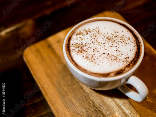 hot chocolate in a white cup , on wood table