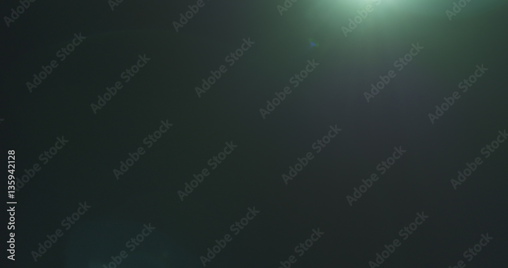 Obraz premium green lens flare artifacts over black background for overlay, 4k photo