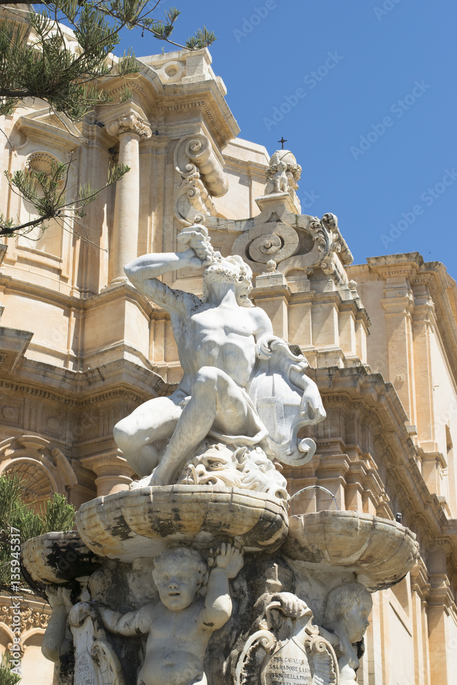 Magic Baroque Fountain with a figure of Neptune  in the historical center of Noto, Sicily