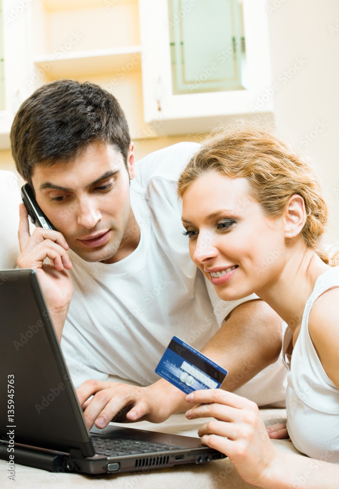 couple with laptop, paying by credit card in internet couple with laptop, paying by credit card in internet