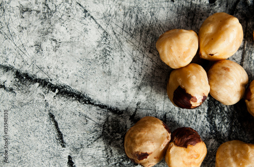 Roasted hazelnuts close up on wood desk.