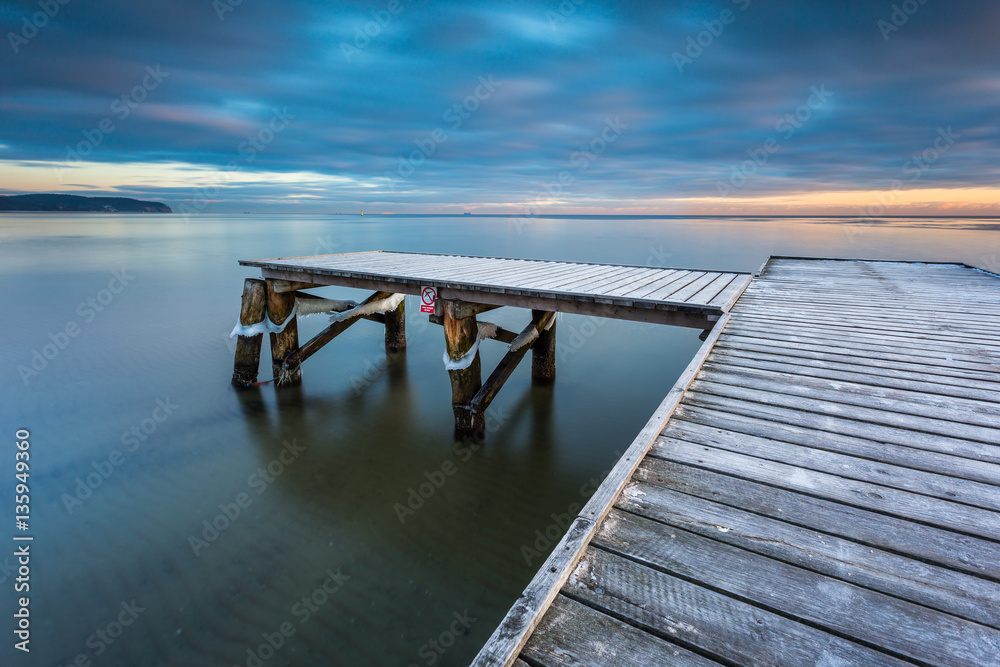 Early morning at frozen small pier at beach in Sopot. Winter landscape in Sopot, Poland.