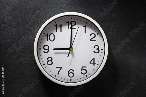 wall clock at black background