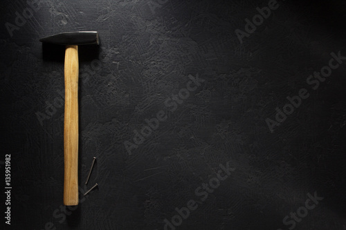 hammer tool and nail at black