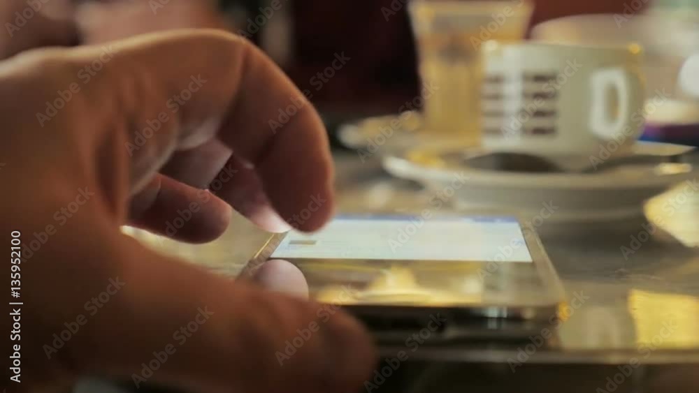 hand of man using smartphone at breakfast hand of man using smartphone at breakfast