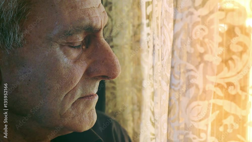 old man suffers looking at the window old man suffers looking at the window
