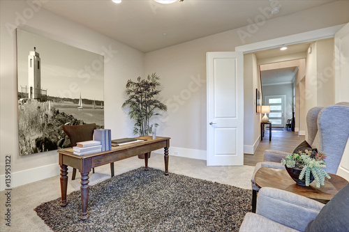 Brown and beige office design boasts wood table with turned legs