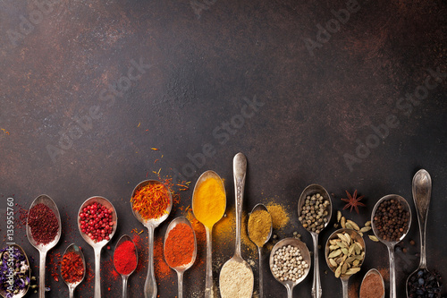 Fototapeta Naklejka Na Ścianę i Meble -  Various spices spoons on stone table