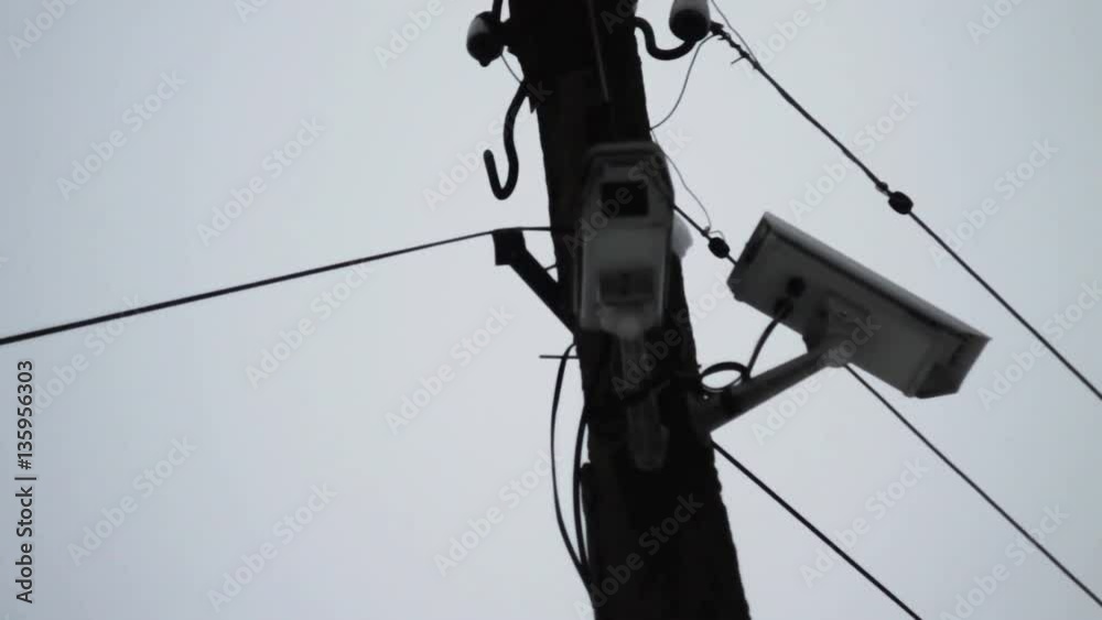 surveillance camera on a lamp post on blue sky background.CCTV surveillance camera on a lamp post on blue sky background.CCTV