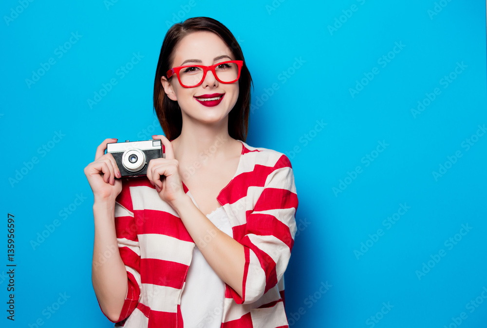 young smiling woman with retro camera