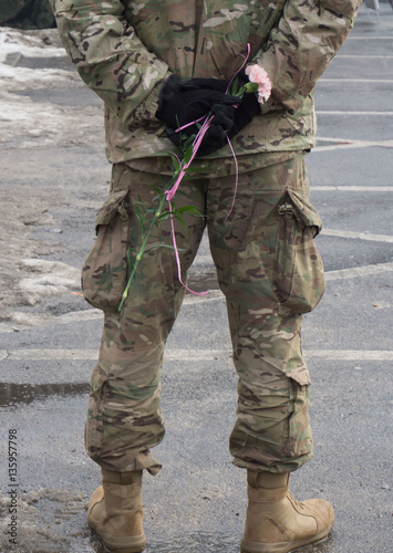 Boleslawiec, Poland, unidentified soldier keeps a rose during the military pickink organized by american and polish soldiers on February 5 in Boleslawiec Poland photo