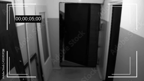 an armed young man in the mask breaks the door and smashes the security camera and handle a gun