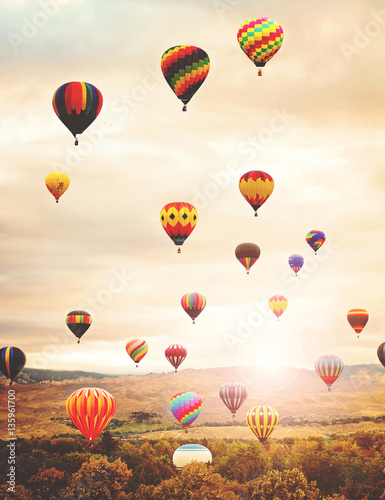 hot air balloons in the sky during sunrise toned with a retro vintage filter