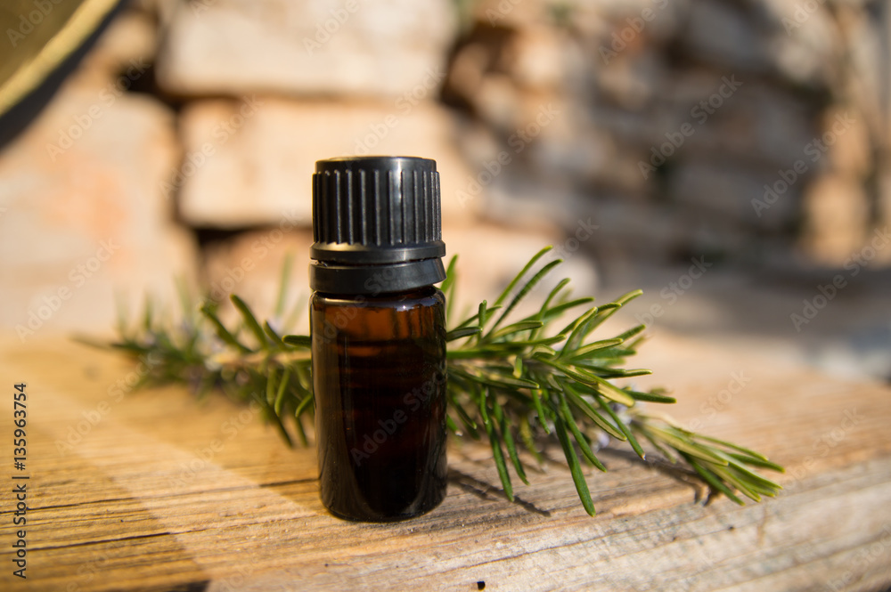 Rosemary oil in small glass bottle Rosemary oil in small glass bottle
