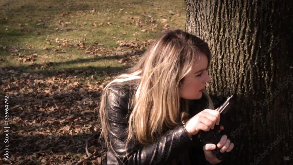 Female Secret Agent hides behind tree with gun V3   Action Movie Shots