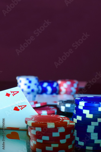 Poker player has pair of aces in pocket pair and lots of chips.