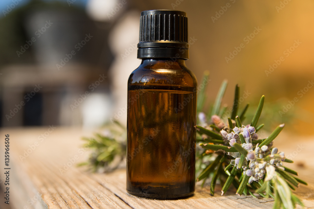 Rosemary oil in small glass bottle