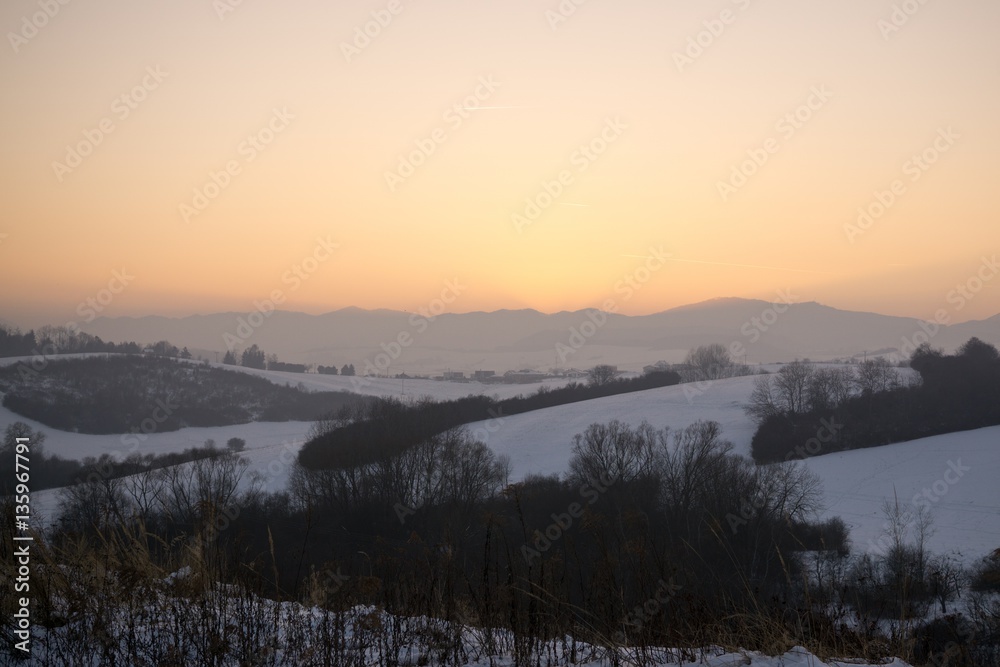 Sunset on meadow with snow during winter. Slovakia