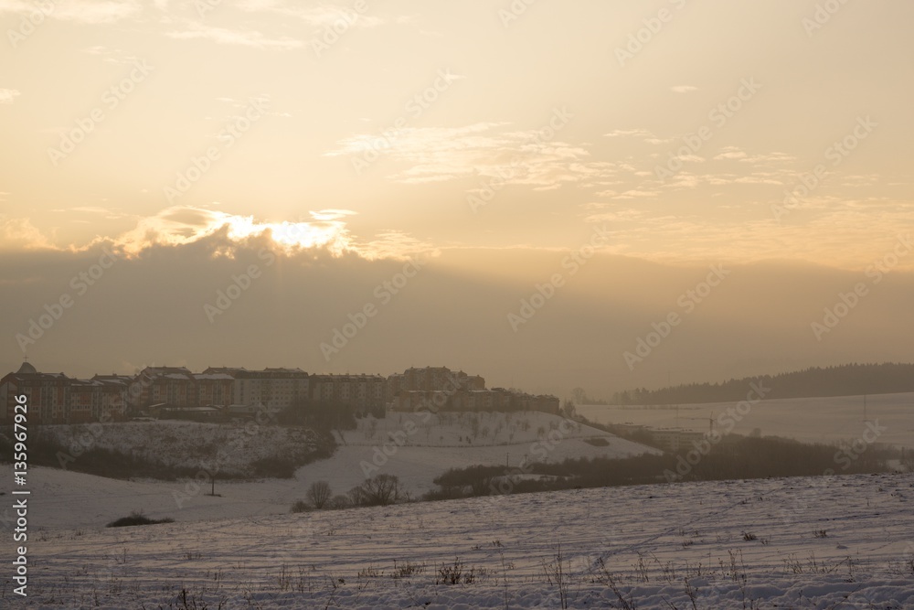 Sunrise on meadow covered by snow during winter. Slovakia