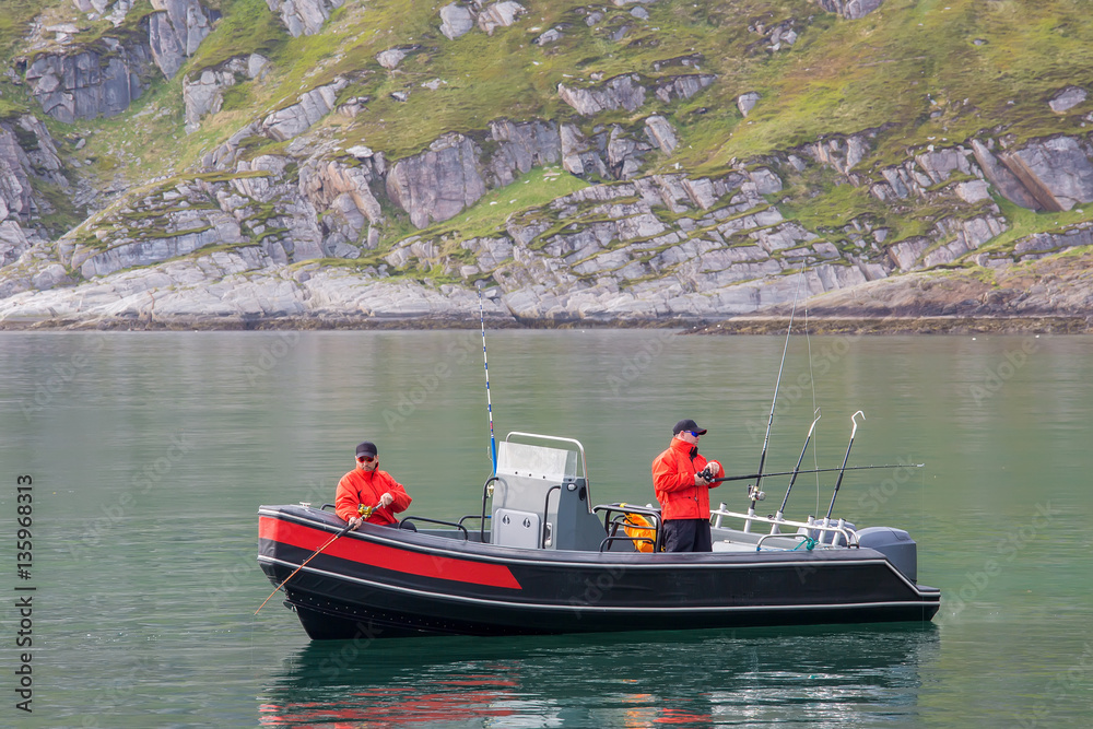 two fishermen catch fish from a boat two fishermen catch fish from a boat
