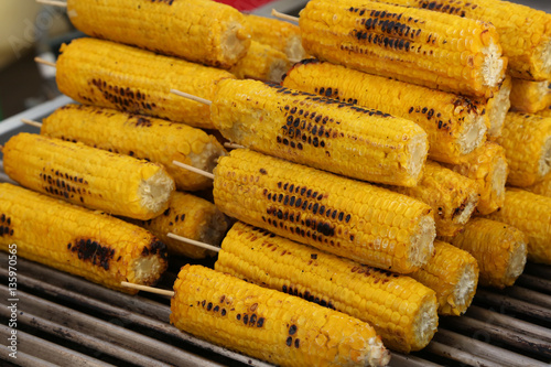 roasted yellow corn for sale in street food stall photo