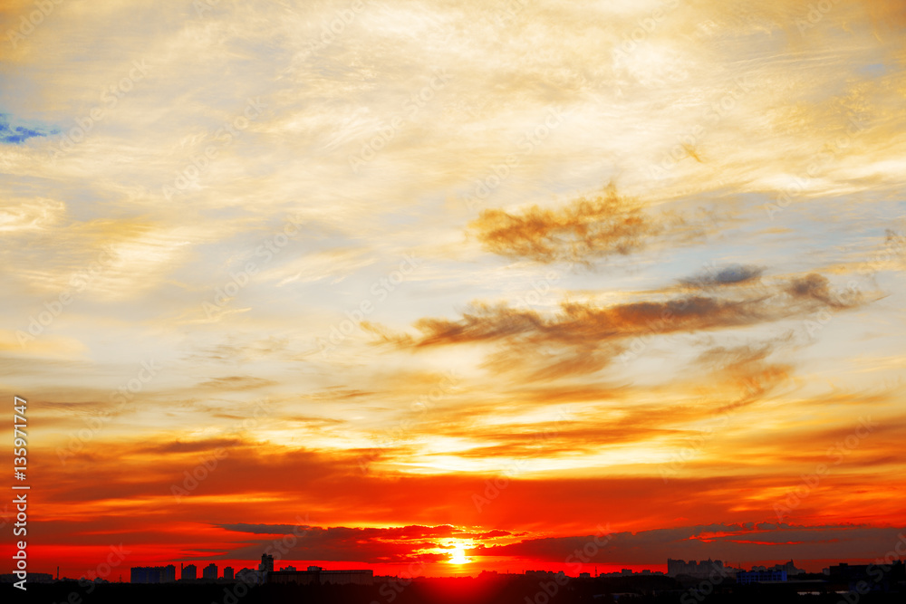 Sunrise in city landscape. Urban sunset. Rays of the sun above t