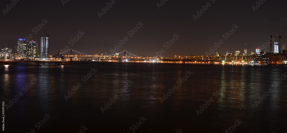 New York Skyline reflected in water, view at night from Brooklyn