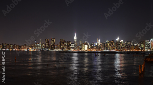 New York Skyline reflected in water, view at night from Brooklyn