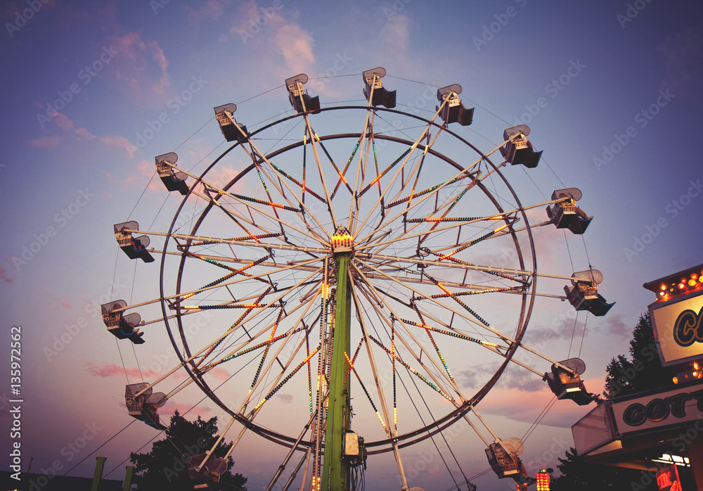 a fair ride during dusk on a warm summer evening toned with a r a fair ride during dusk on a warm summer evening toned with a r