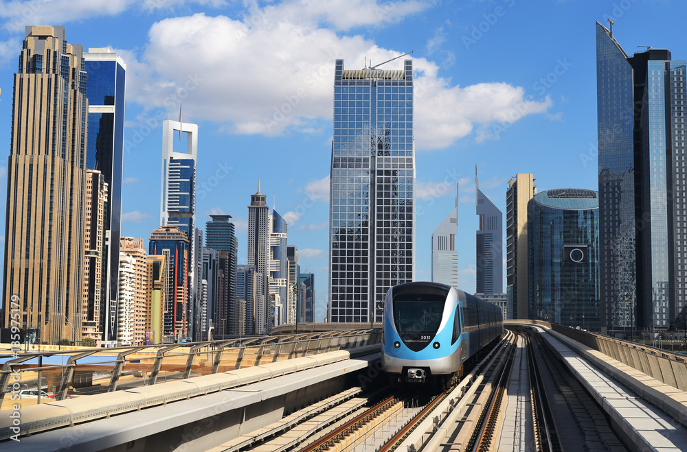 Obraz premium Metro train moving through the skyscrapers